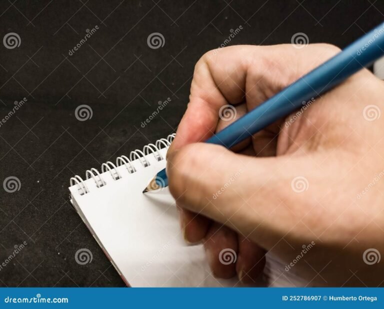 manos escribiendo en un cuaderno educativo